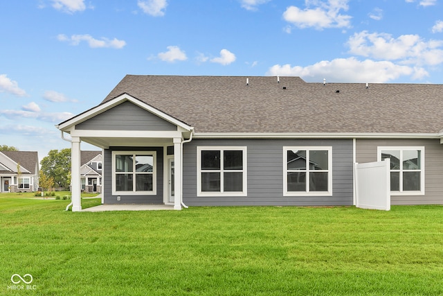 back of house with a lawn