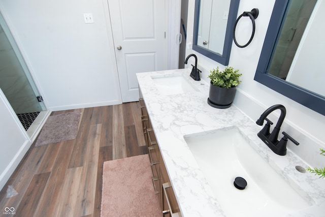 bathroom with an enclosed shower, vanity, and hardwood / wood-style flooring