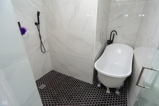 bathroom featuring tile walls and plus walk in shower