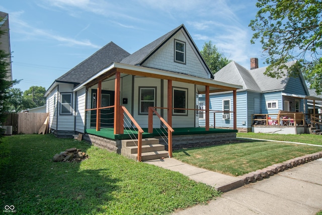 view of front facade with a front yard and covered porch