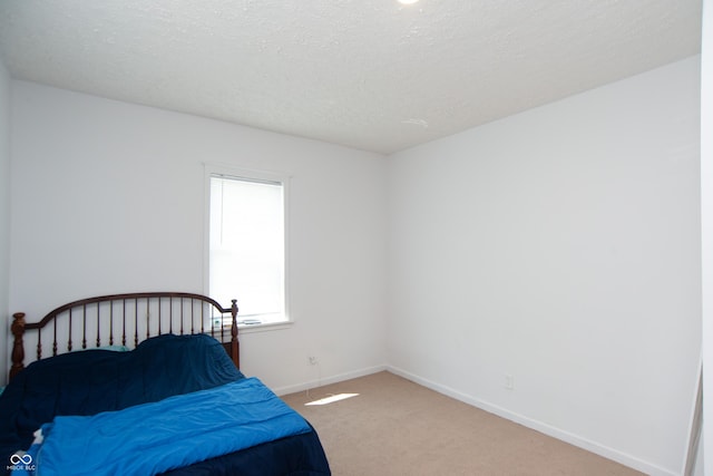 carpeted bedroom with a textured ceiling