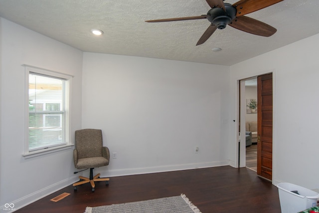 sitting room featuring dark hardwood / wood-style floors and a textured ceiling