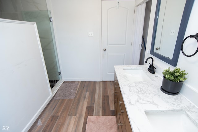 bathroom featuring vanity, hardwood / wood-style floors, and a shower