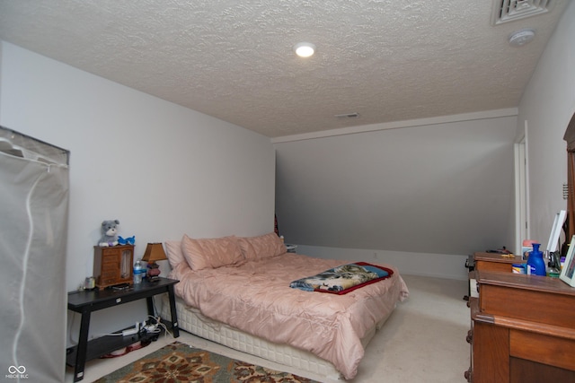 carpeted bedroom featuring a textured ceiling