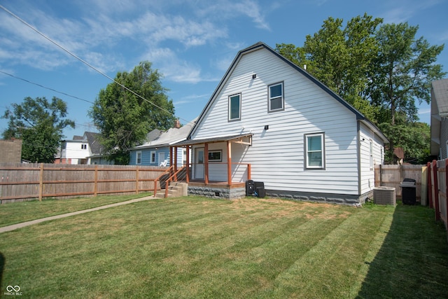 back of property featuring a lawn