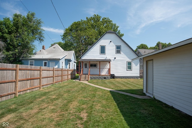 rear view of house with a lawn