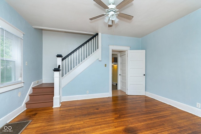 unfurnished living room featuring ceiling fan and dark hardwood / wood-style floors