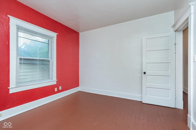 spare room featuring dark hardwood / wood-style flooring