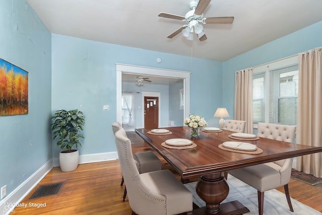 dining room with hardwood / wood-style flooring and ceiling fan