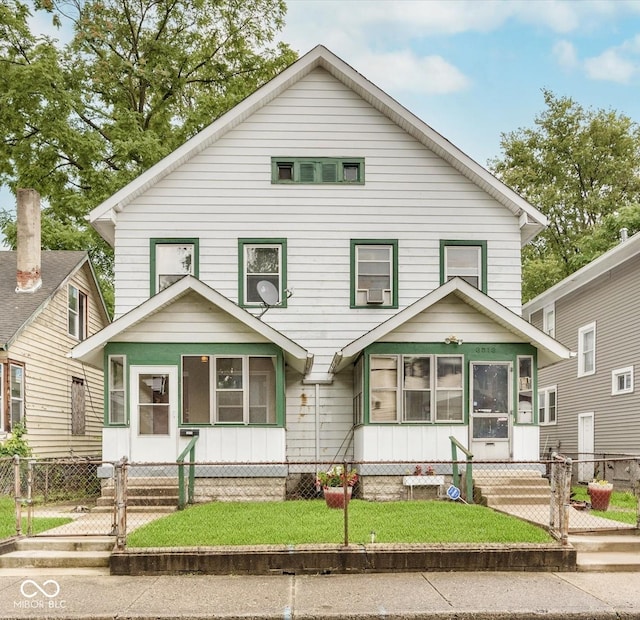 view of front of house with a fenced front yard and a gate