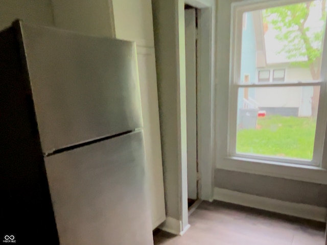 kitchen featuring stainless steel refrigerator and a healthy amount of sunlight