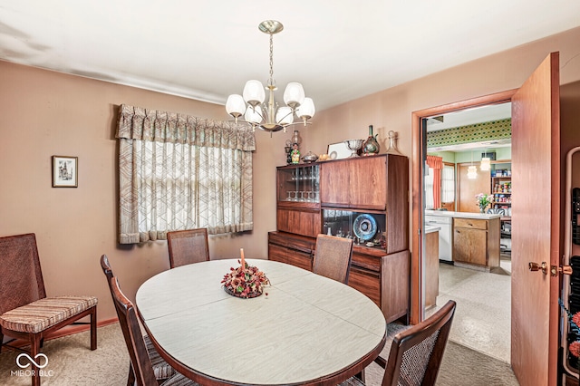 carpeted dining area featuring a notable chandelier