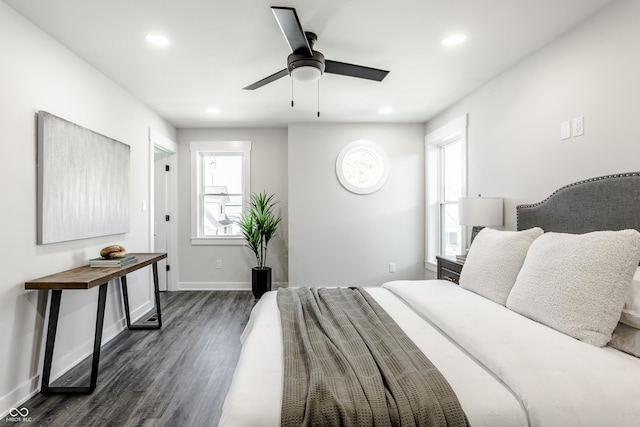 bedroom featuring recessed lighting, multiple windows, dark wood finished floors, and baseboards