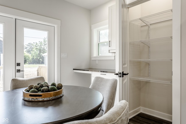 dining area with plenty of natural light, baseboards, and dark wood-type flooring