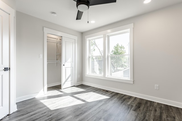 unfurnished bedroom with recessed lighting, wood finished floors, and baseboards