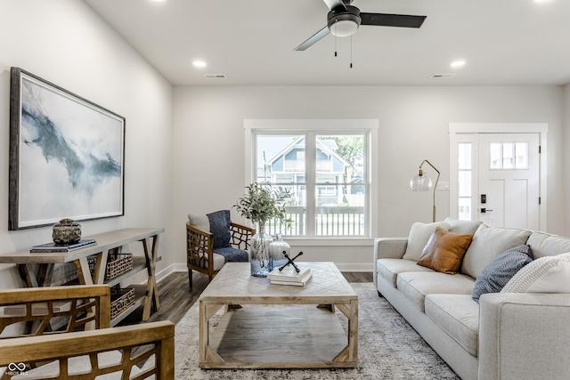 living area featuring recessed lighting, visible vents, and wood finished floors