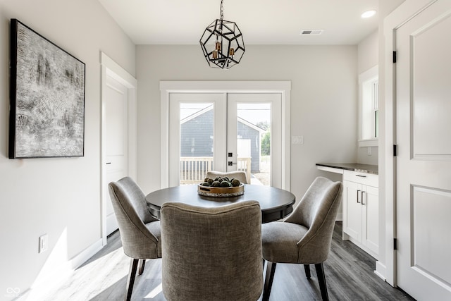 dining room featuring baseboards, visible vents, dark wood finished floors, and french doors