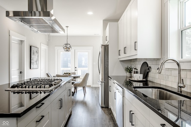 kitchen with dark stone counters, exhaust hood, and white cabinetry