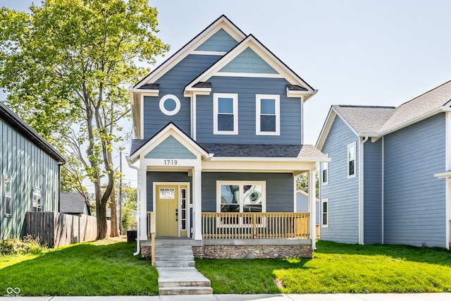 craftsman-style home featuring a porch and a front yard