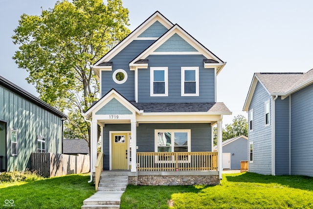 view of front of property with a porch and a front lawn