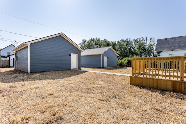 view of yard with an outdoor structure and a wooden deck