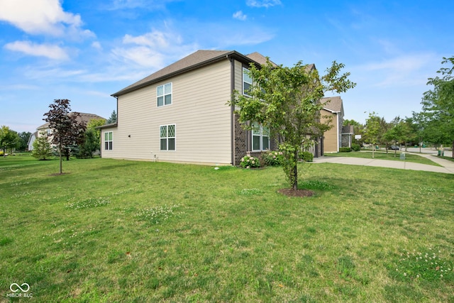 view of side of home featuring a lawn