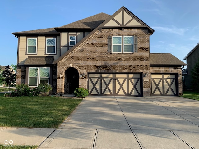 view of front of property featuring a garage and a front lawn