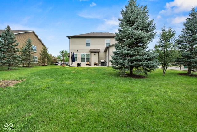 rear view of house with a yard