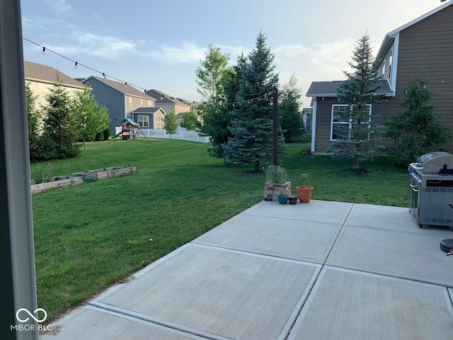 view of yard featuring a playground and a patio