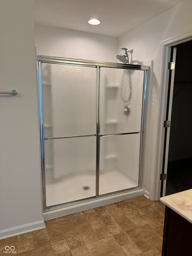 bathroom featuring vanity and a shower with shower door