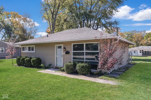 ranch-style home with a front lawn