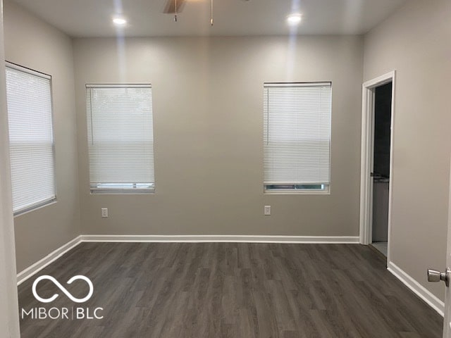 unfurnished room with dark wood-type flooring