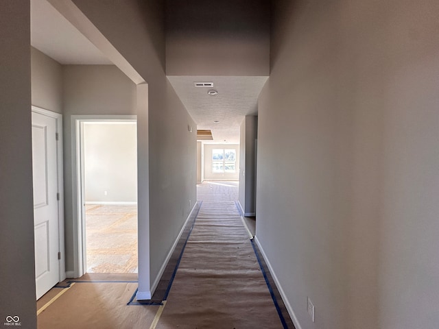 hallway with hardwood / wood-style flooring