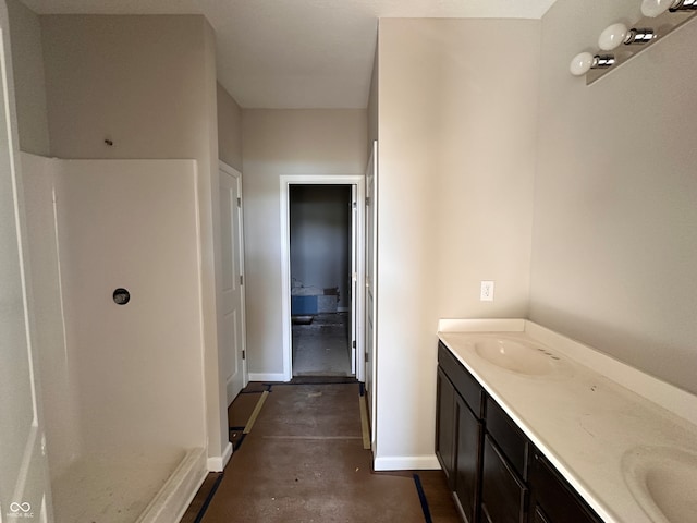 bathroom featuring a shower, vanity, and concrete floors