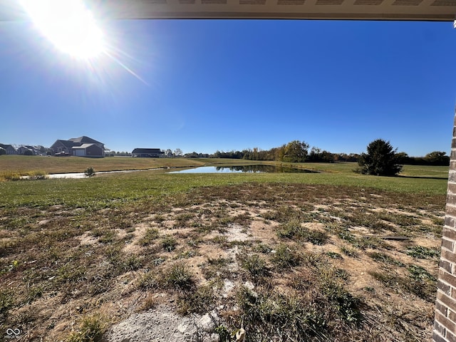 view of yard with a rural view and a water view