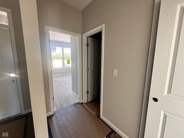 corridor with dark colored carpet