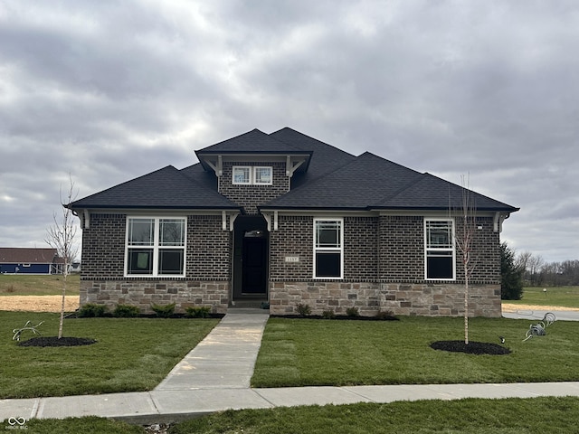 1157 Paul Revere Dr, Mooresville, IN 46158 - view of front of property featuring a front yard, a shingled roof, stone siding, and brick siding