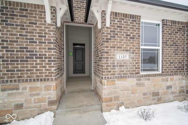 view of snow covered property entrance