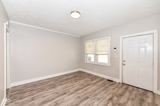 foyer with a textured ceiling and hardwood / wood-style flooring