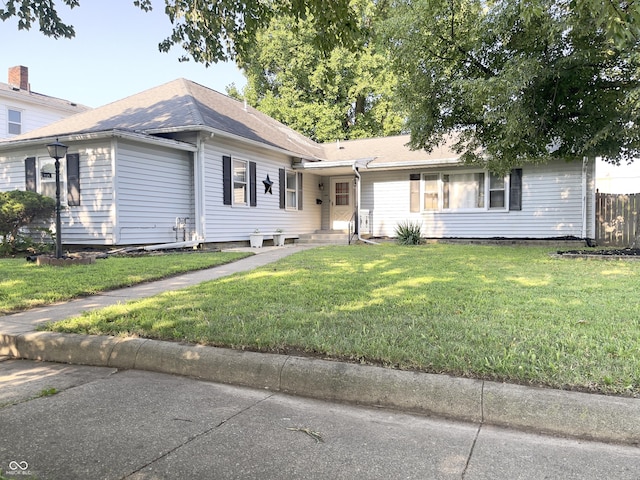 single story home featuring a front lawn