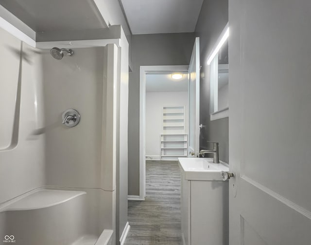 bathroom featuring vanity, hardwood / wood-style floors, and walk in shower