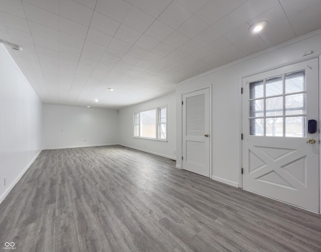 interior space with hardwood / wood-style floors and crown molding