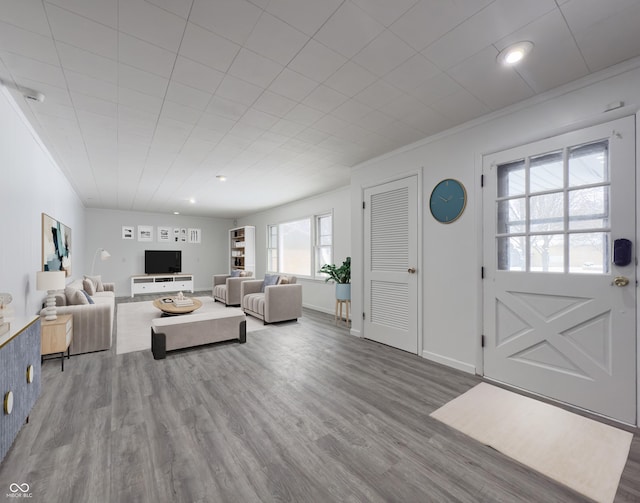 living room with hardwood / wood-style floors and ornamental molding