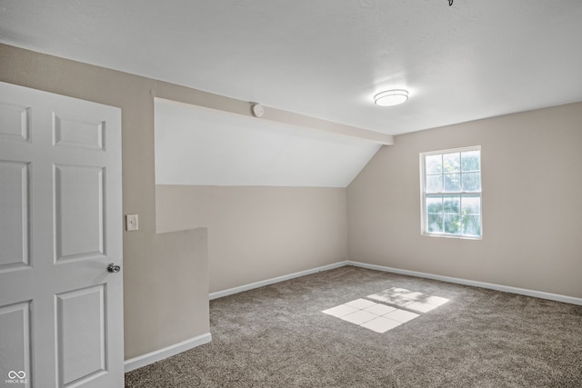 bonus room featuring carpet floors and vaulted ceiling