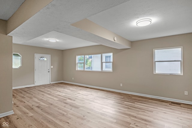 entryway featuring light hardwood / wood-style flooring and a textured ceiling