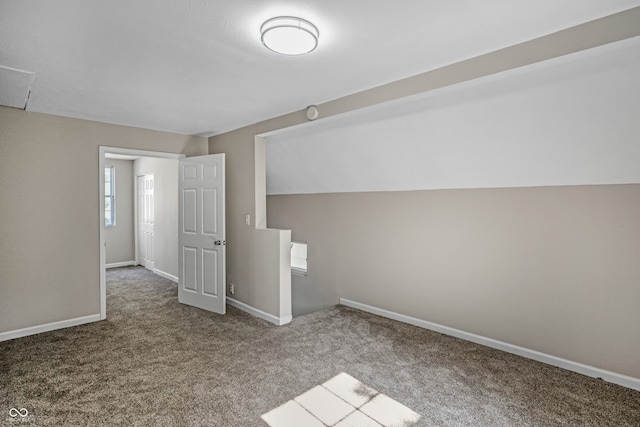 bonus room with carpet floors and vaulted ceiling