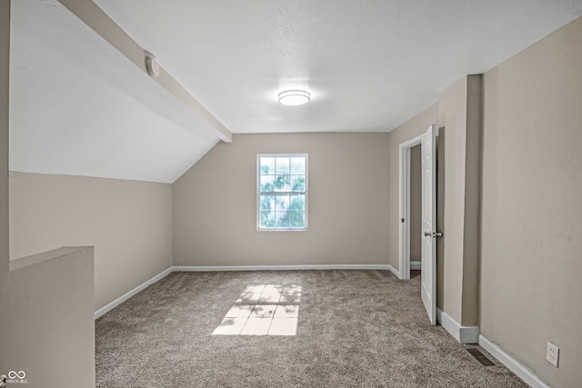 additional living space featuring carpet floors and vaulted ceiling