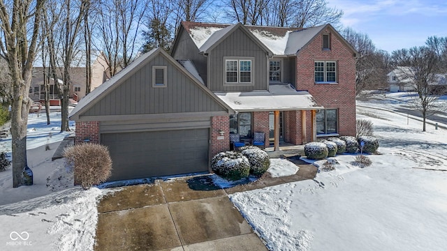 traditional-style home featuring board and batten siding, brick siding, driveway, and an attached garage