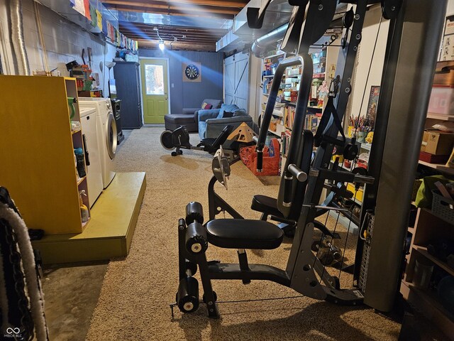 exercise room featuring washing machine and dryer