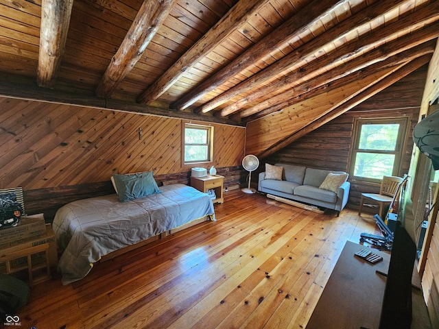 bedroom with vaulted ceiling with beams, wood ceiling, wood walls, and wood finished floors